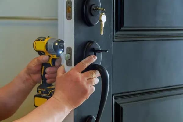 Locksmith working on a door lock
